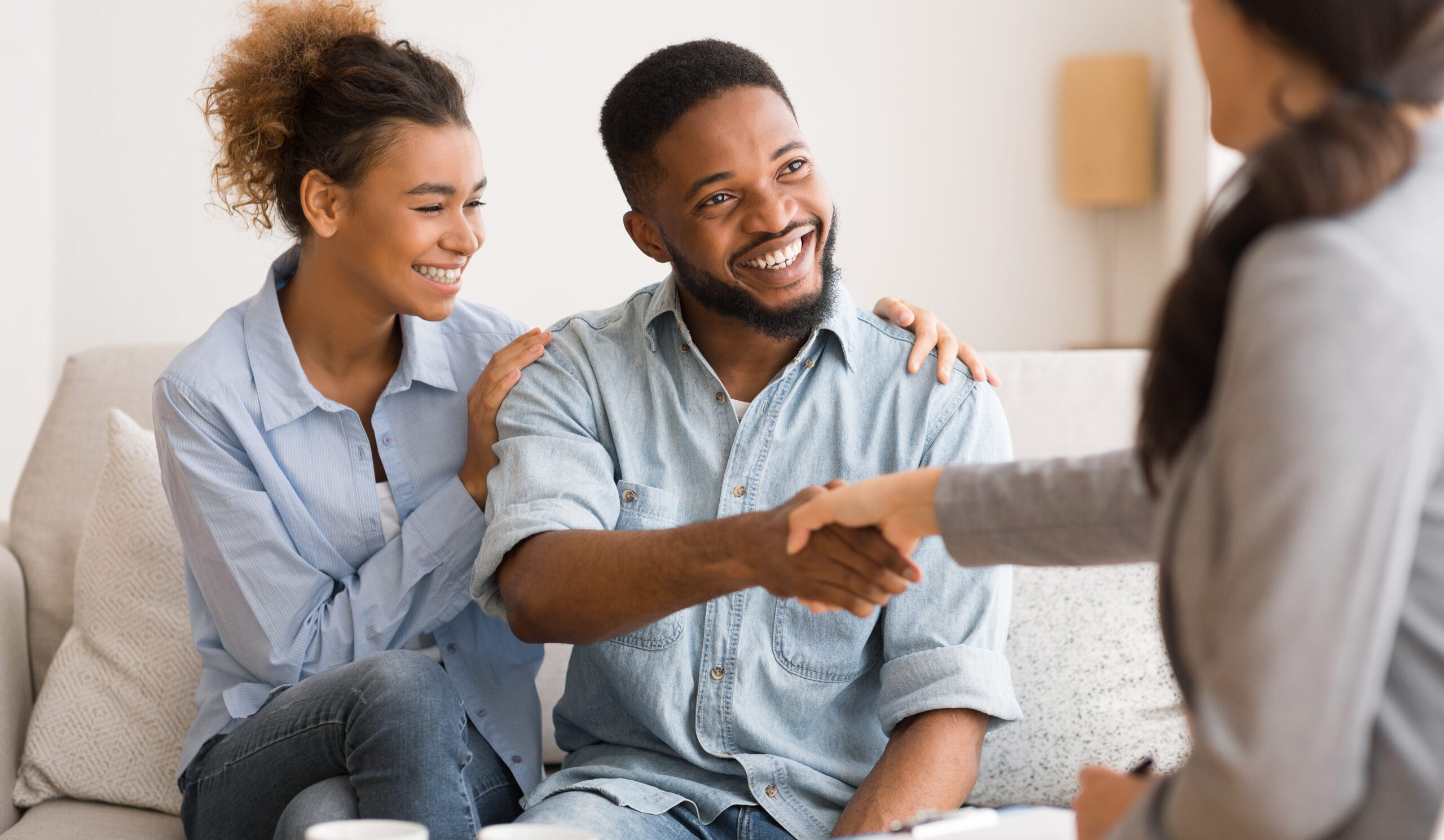 Saved Marriage. Cheerful Young Afro Couple Handshaking With Marital Therapist After Session. Selective Focus